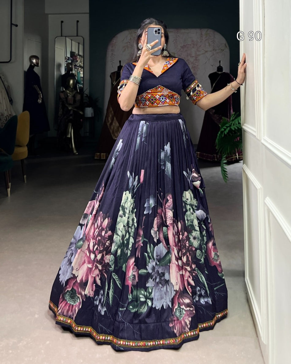 Person wearing a traditional outfit with a floral design in a room.