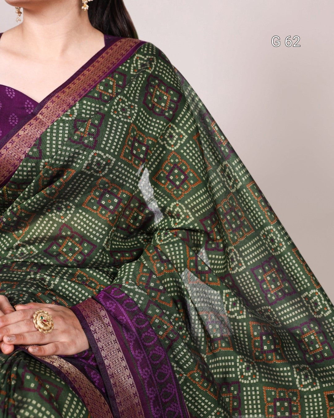 Green and purple patterned saree with a plain background