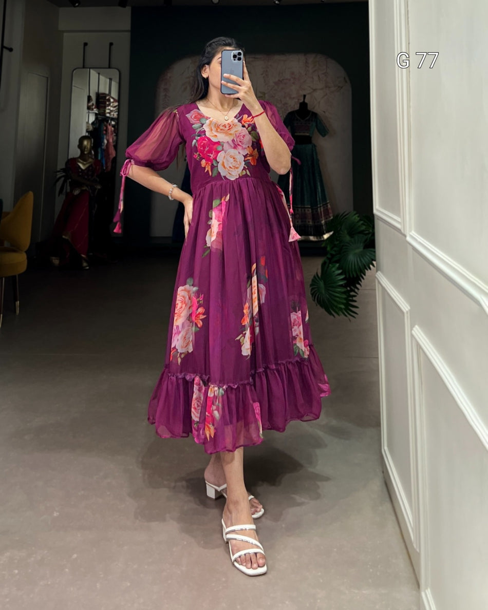 Person wearing a purple floral dress taking a mirror selfie in an indoor setting.