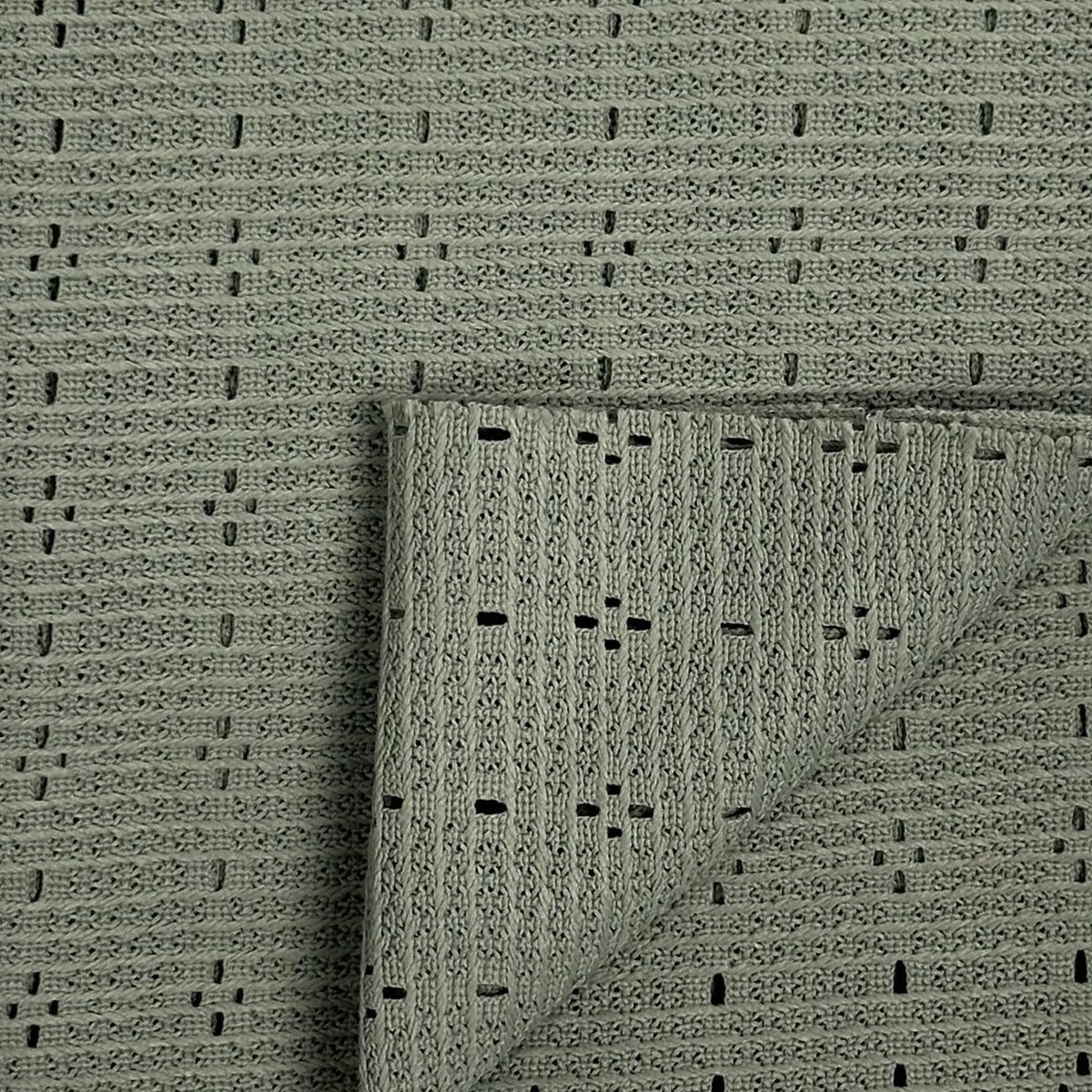 Textured green rug with a folded corner on a matching background