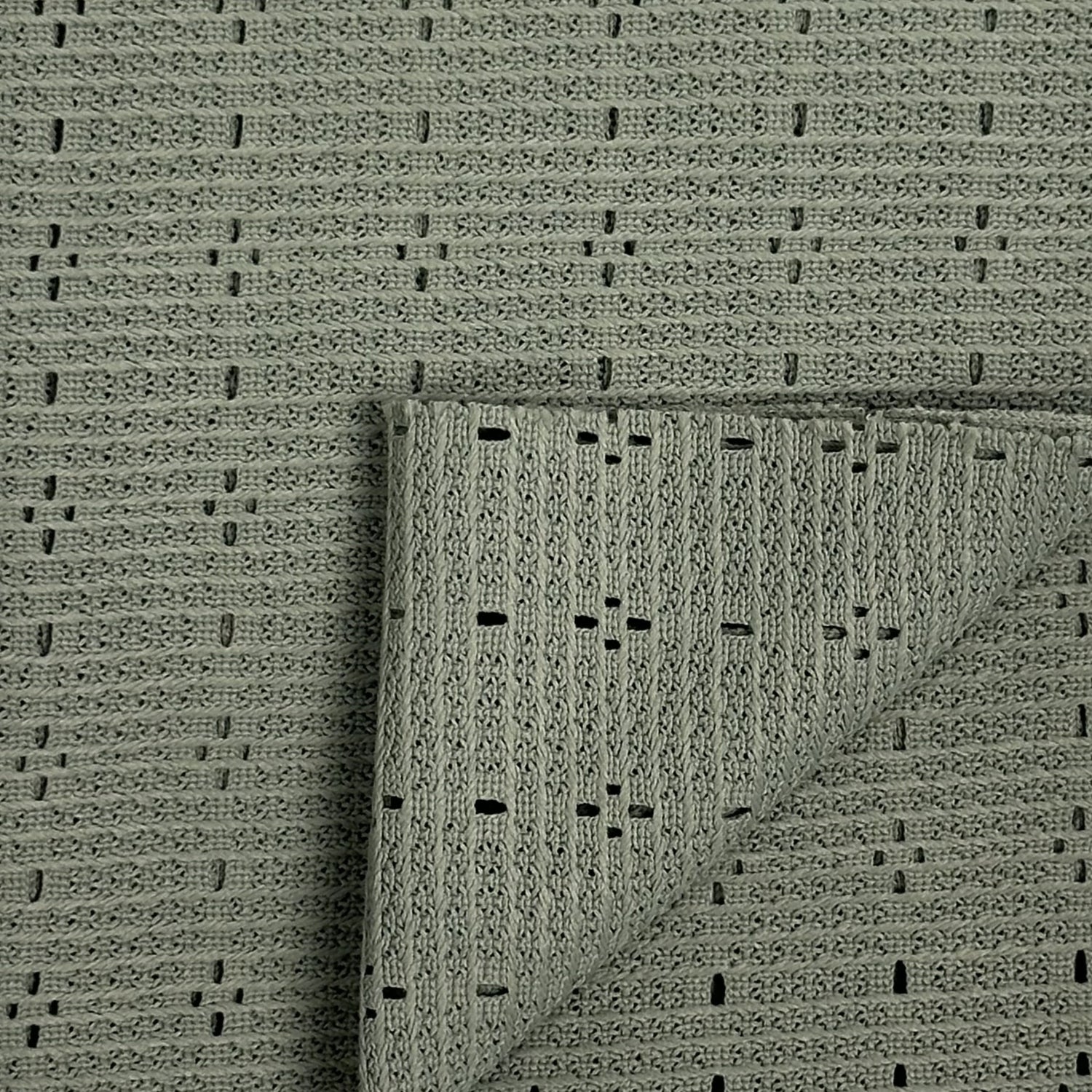 Textured green rug with a folded corner on a matching background