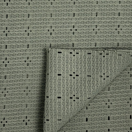 Textured green rug with a folded corner on a matching background
