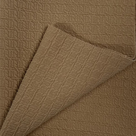 Close-up of brown textured fabric with a folded edge