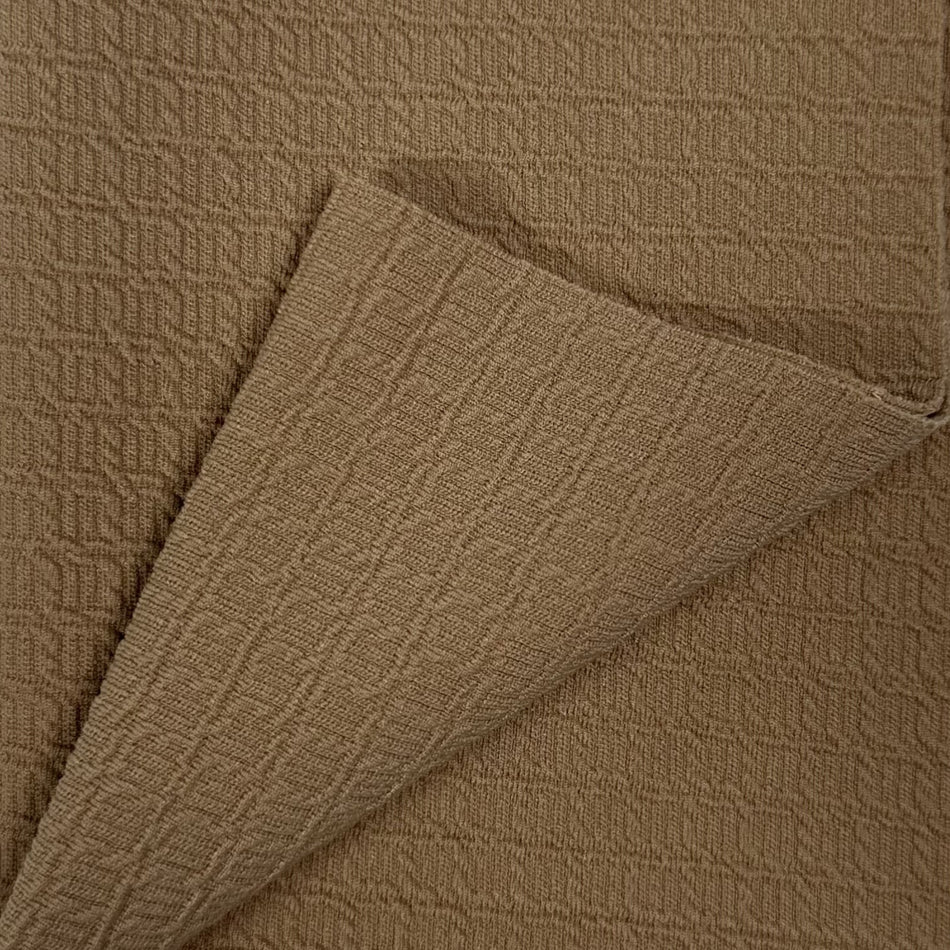 Close-up of brown textured fabric with a folded edge