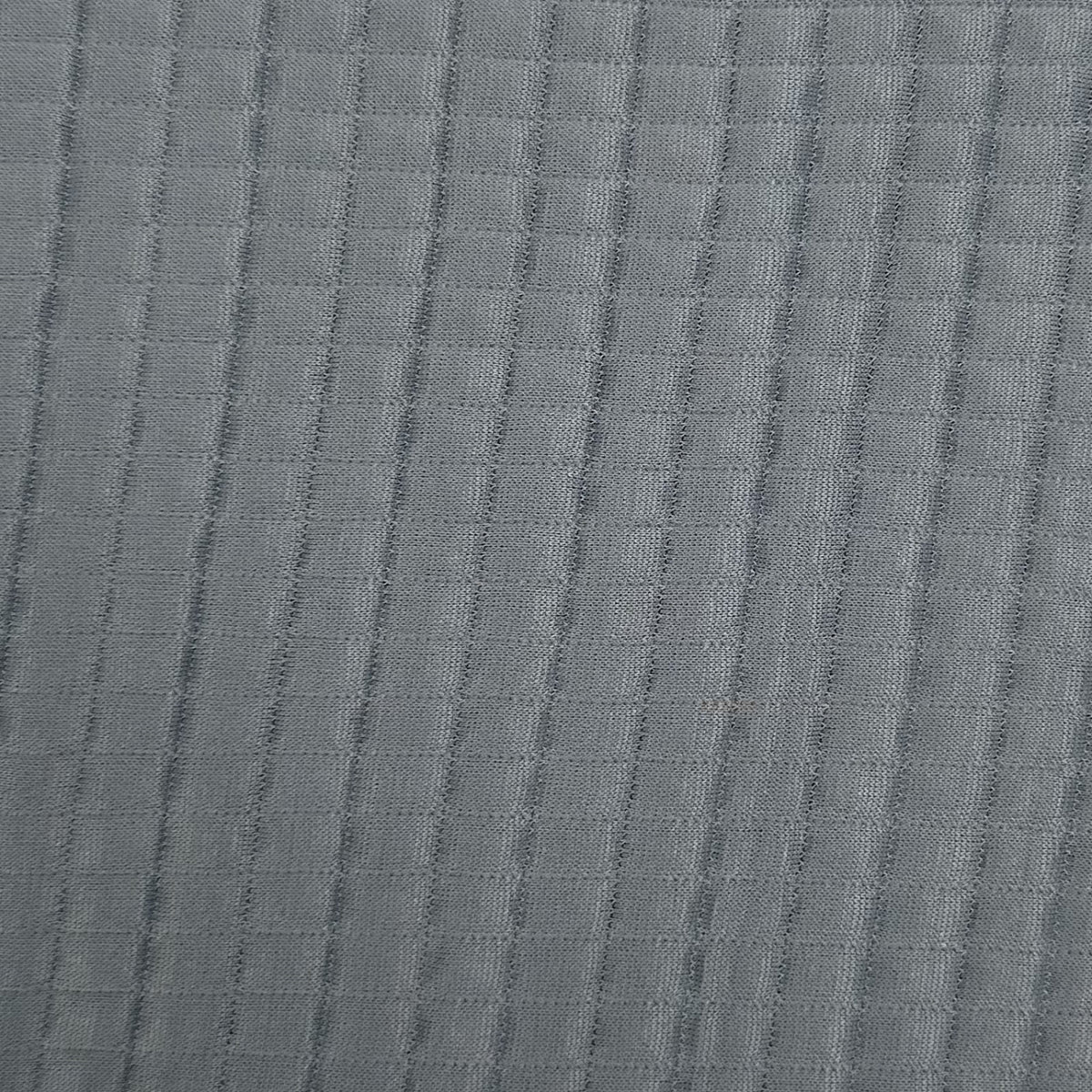 Close-up of textured gray fabric with a subtle pattern