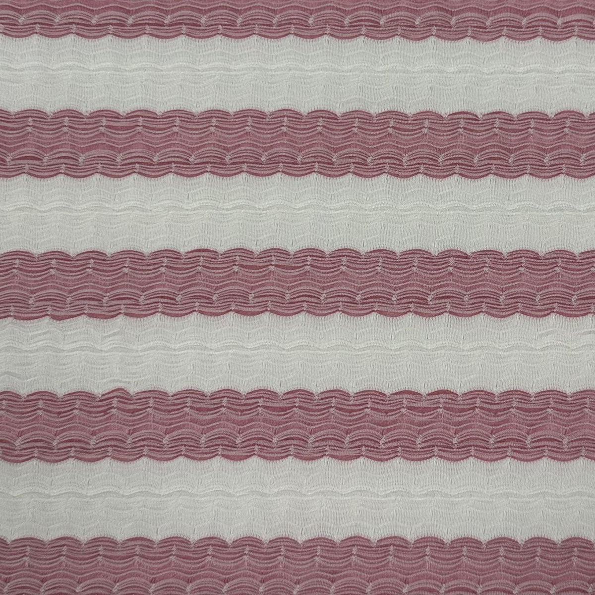 Textured fabric with wavy pattern and alternating pink and gray stripes
