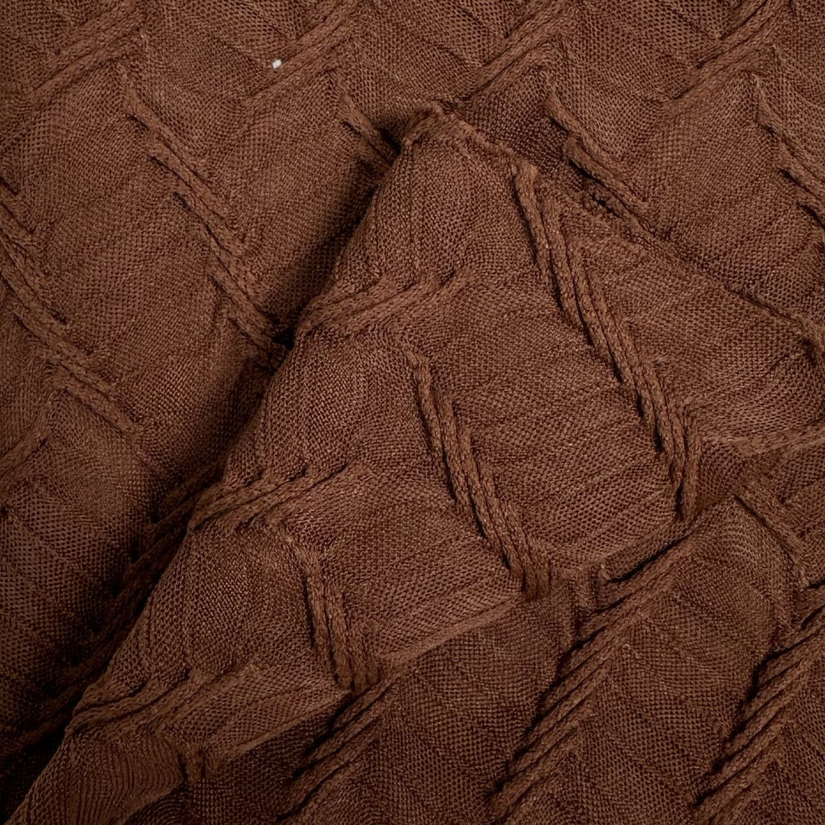 Close-up of brown textured fabric with a diamond pattern