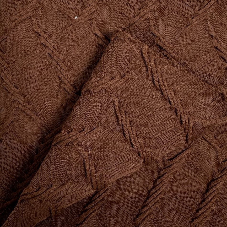 Close-up of brown textured fabric with a diamond pattern