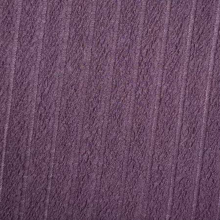 Close-up of textured purple fabric with a subtle pattern
