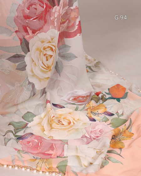 Floral patterned fabric with pink, white, and orange flowers on a light background.