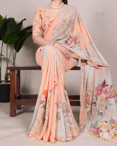 Woman wearing a floral saree with a light background