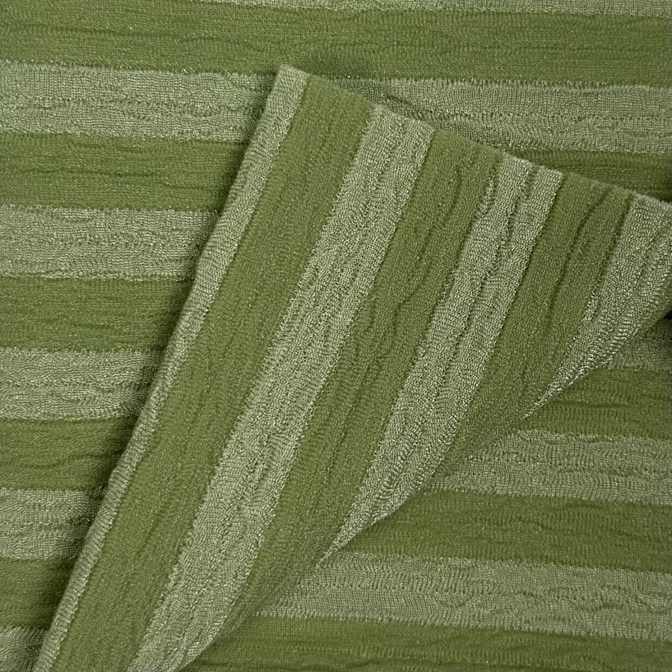 Close-up of green textured fabric with diagonal stripes