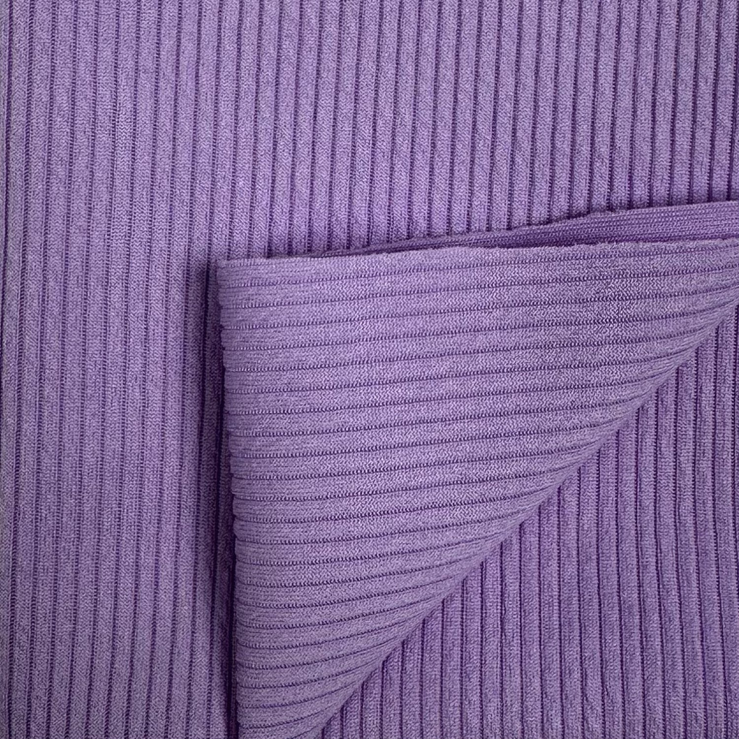 Close-up of purple textured fabric with a diagonal pleat