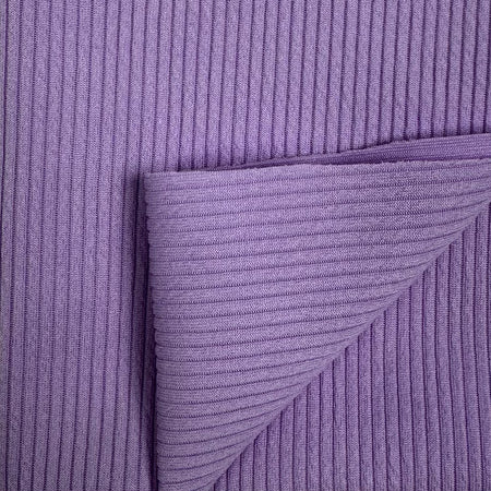 Close-up of purple textured fabric with a diagonal pleat