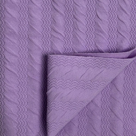 Close-up of textured purple fabric with a folded corner