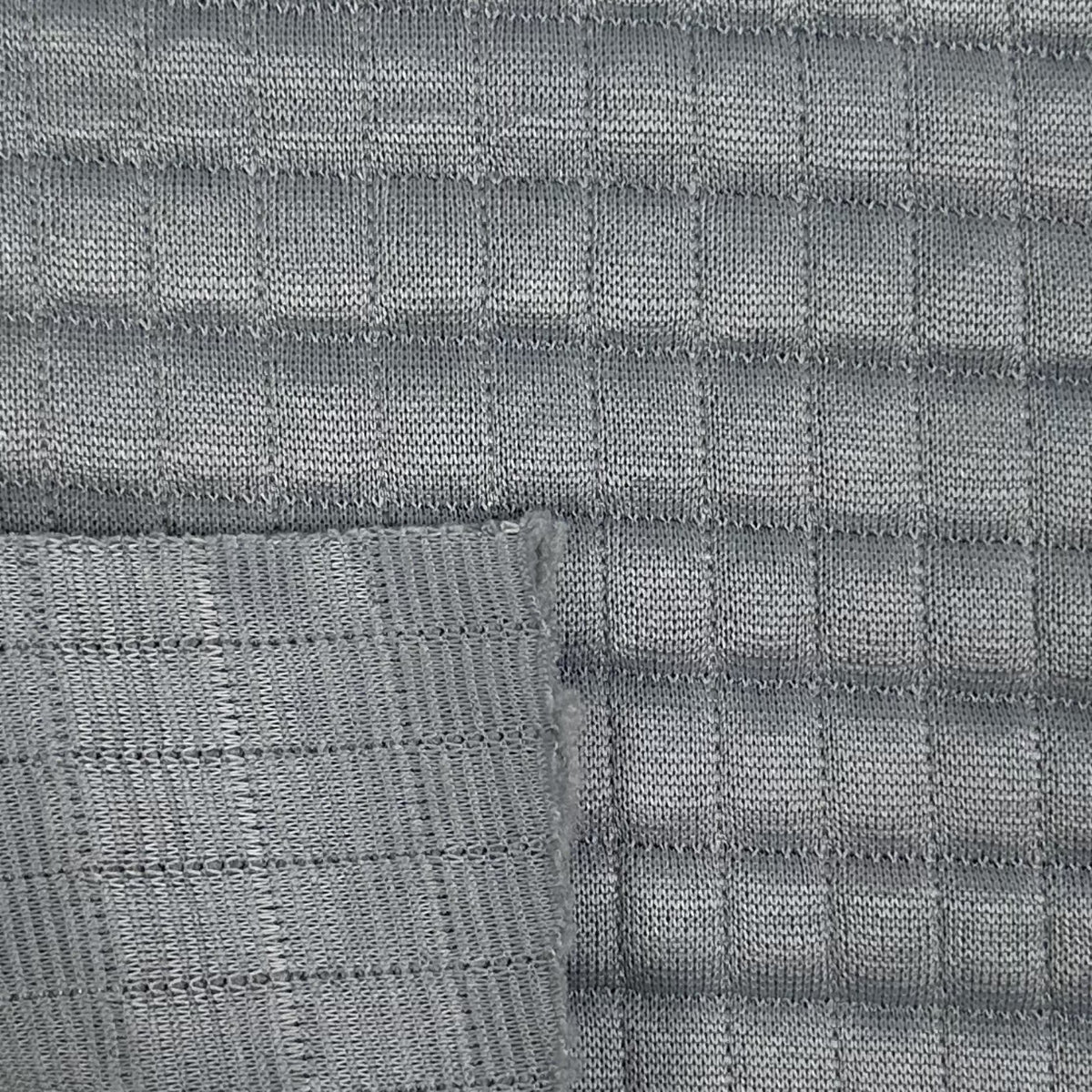 Close-up of gray woven fabric with a grid pattern