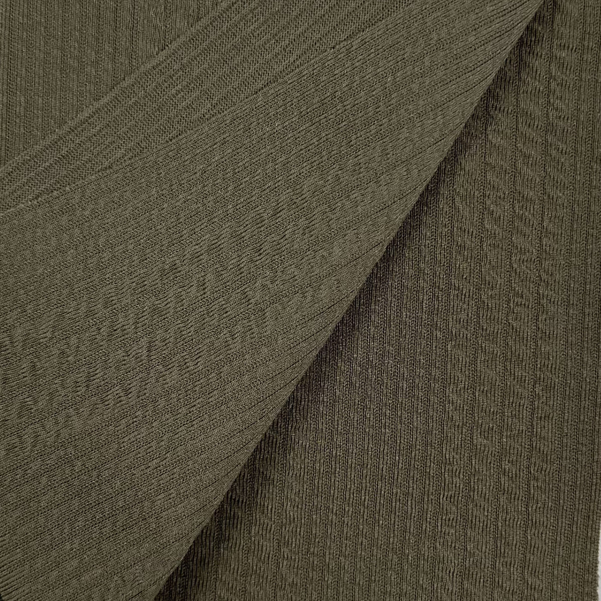 Close-up of textured brown fabric with a diagonal pattern