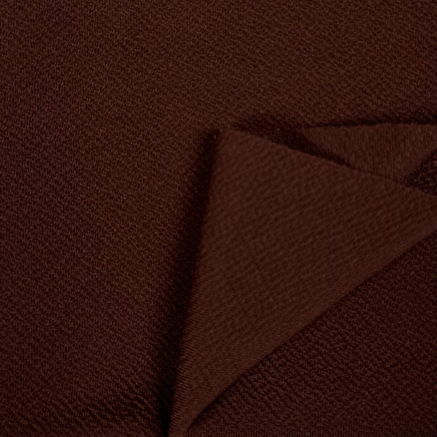 Brown textured fabric with a folded corner