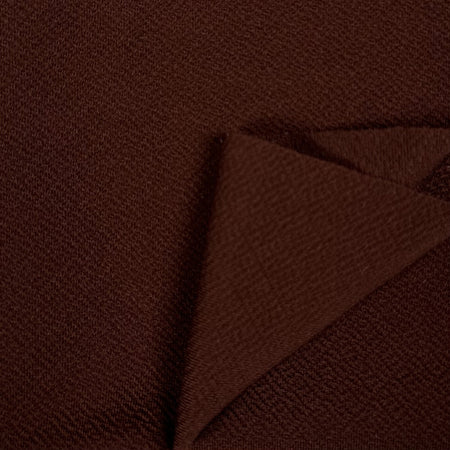 Brown textured fabric with a folded corner