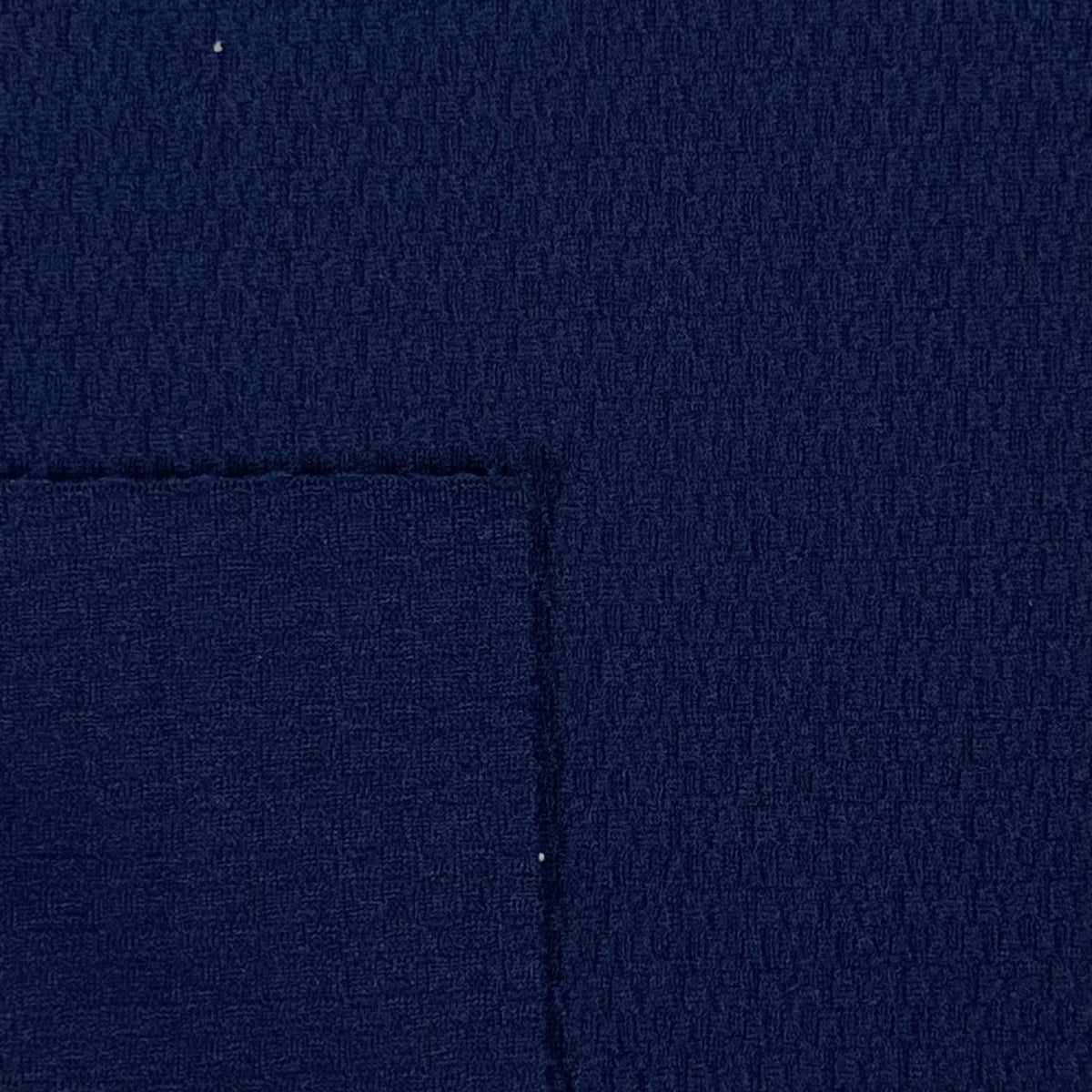 Close-up of dark blue fabric with a visible seam