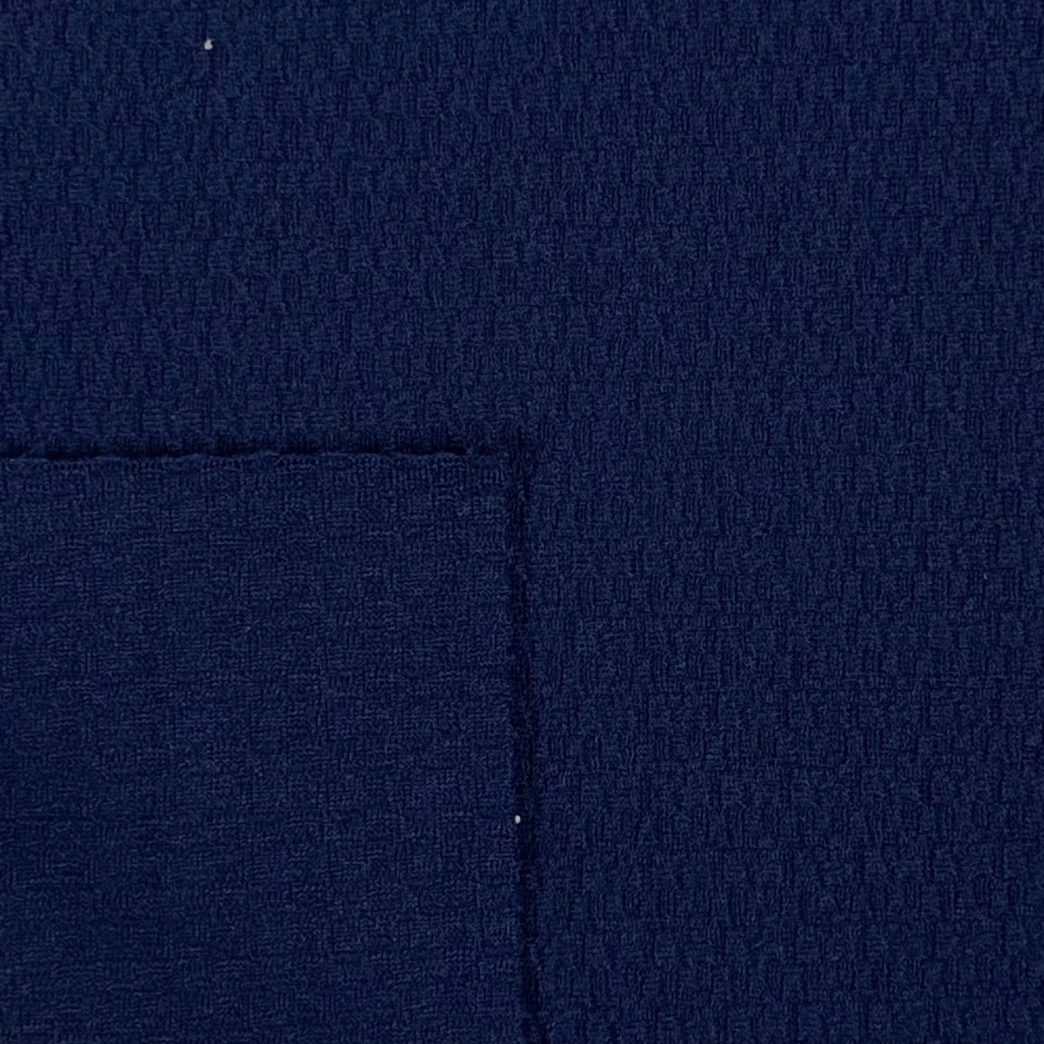 Close-up of dark blue fabric with a visible seam