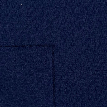 Close-up of dark blue fabric with a visible seam