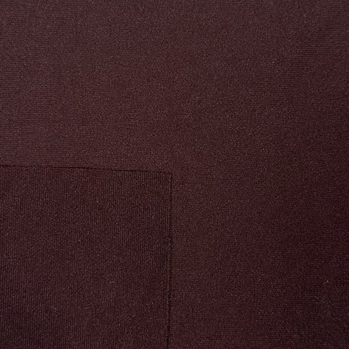 Close-up of brown fabric with a visible seam