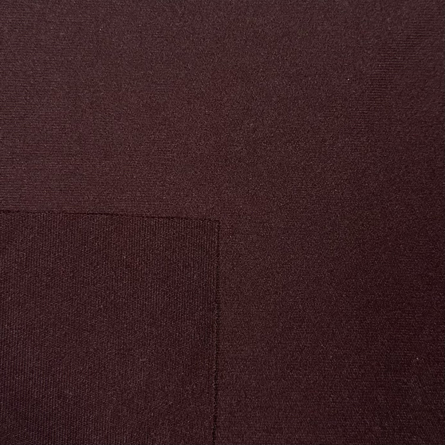 Close-up of brown fabric with a visible seam