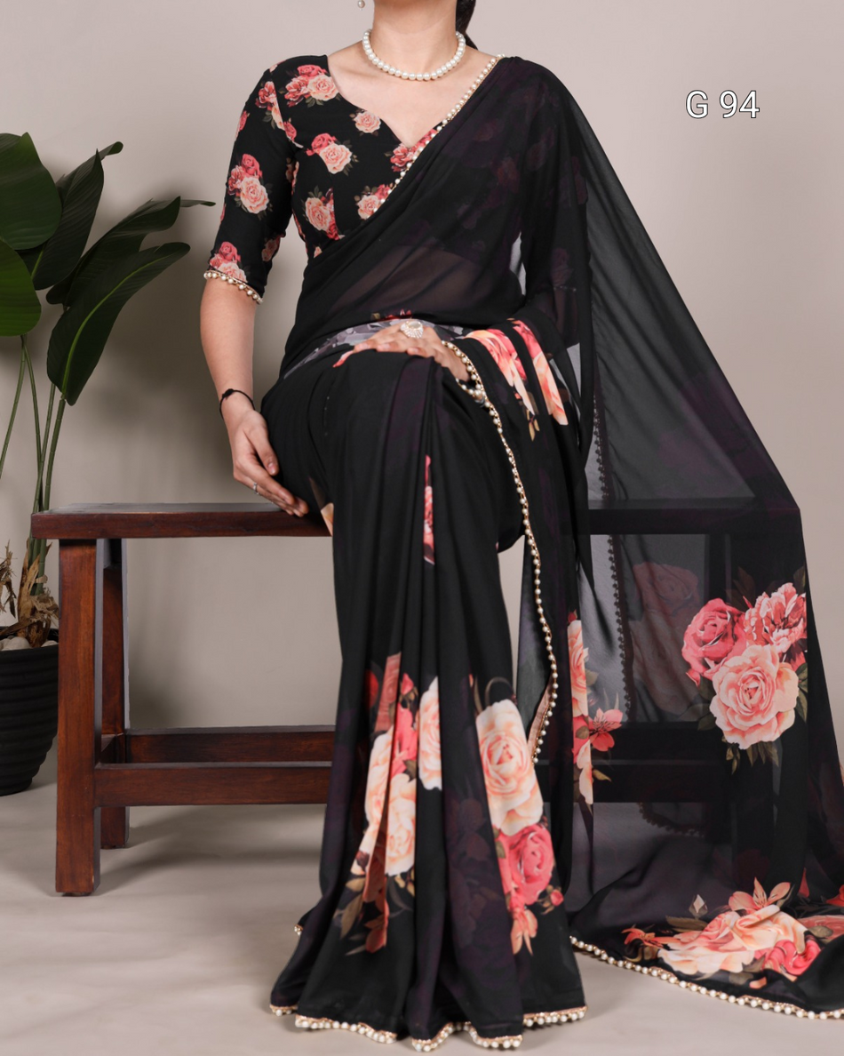 Black saree with floral patterns draped over a chair