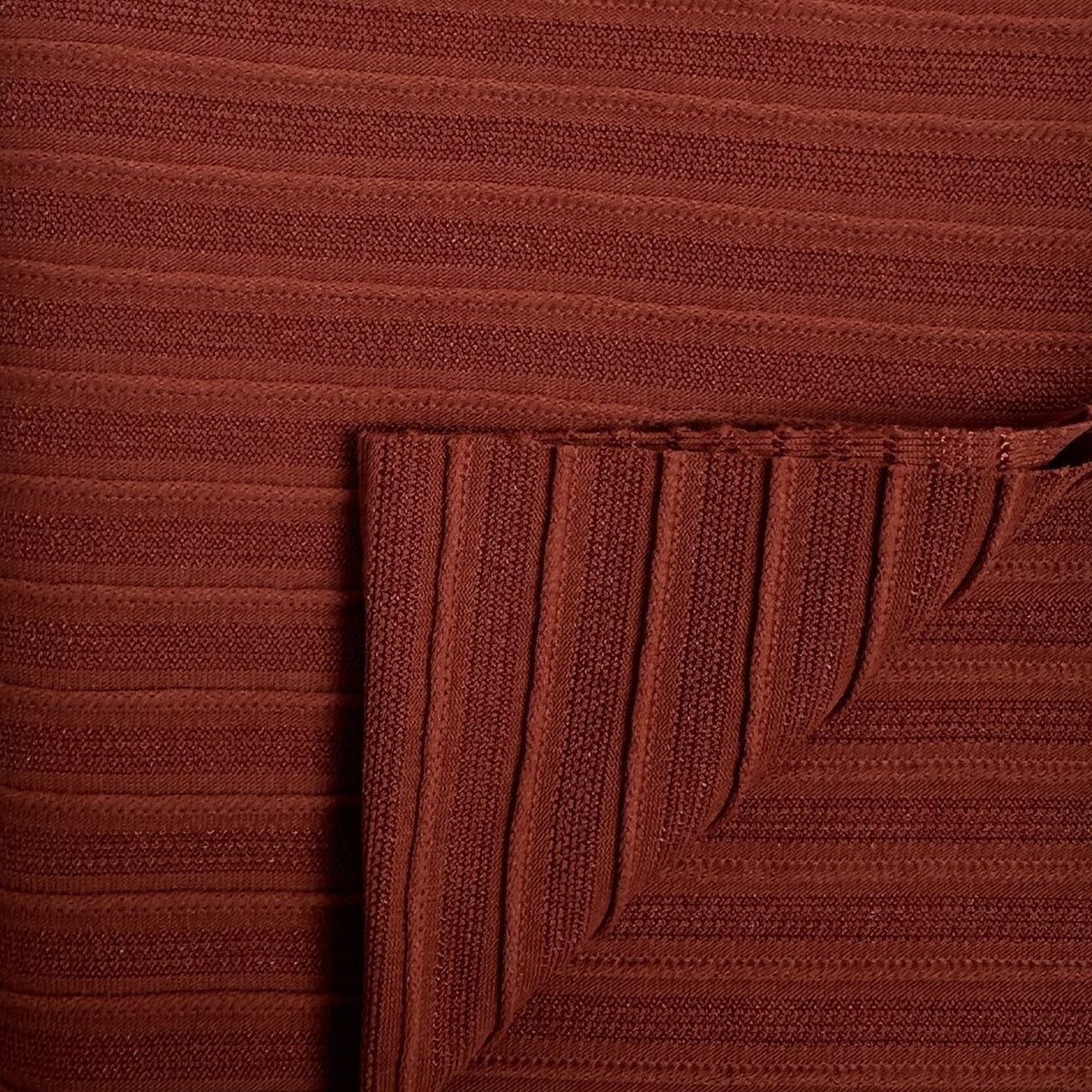 Close-up of a brown textured fabric with a corner folded over