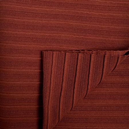 Close-up of a brown textured fabric with a corner folded over