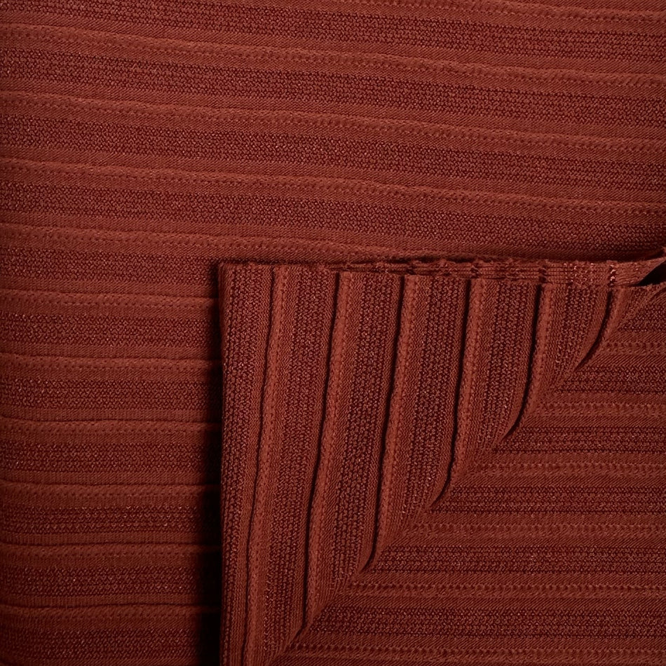 Close-up of a brown textured fabric with a corner folded over