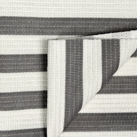 Close-up of a gray and white striped fabric with a visible seam.