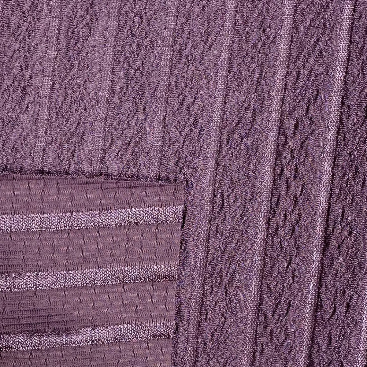 Close-up of textured purple fabric with a cable knit pattern