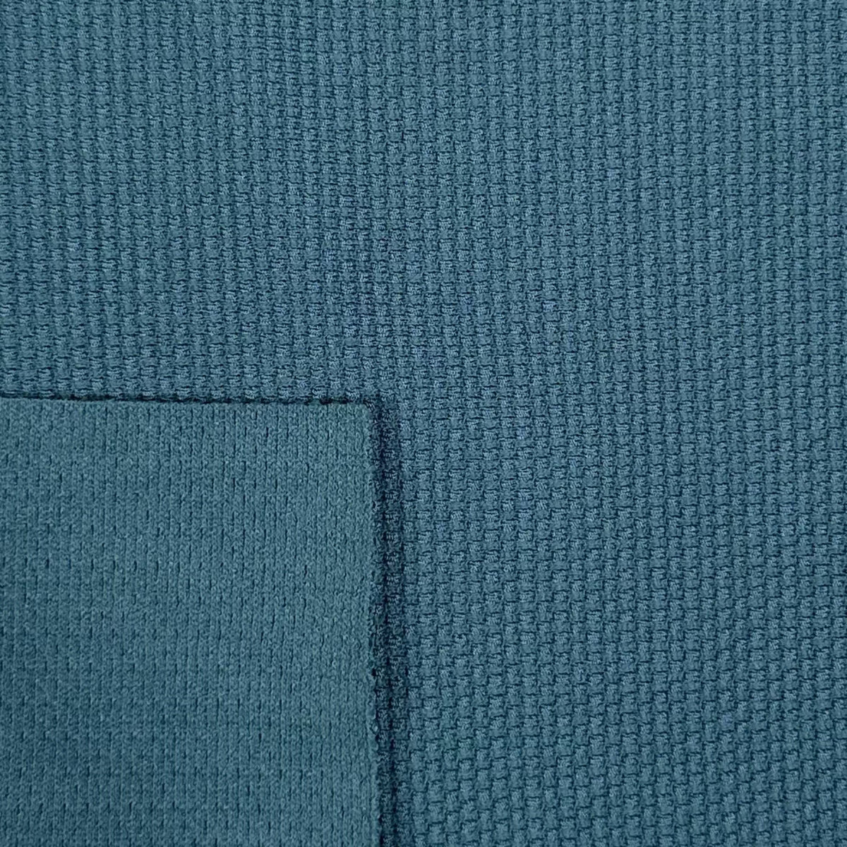 Close-up of textured blue fabric with a slight pattern