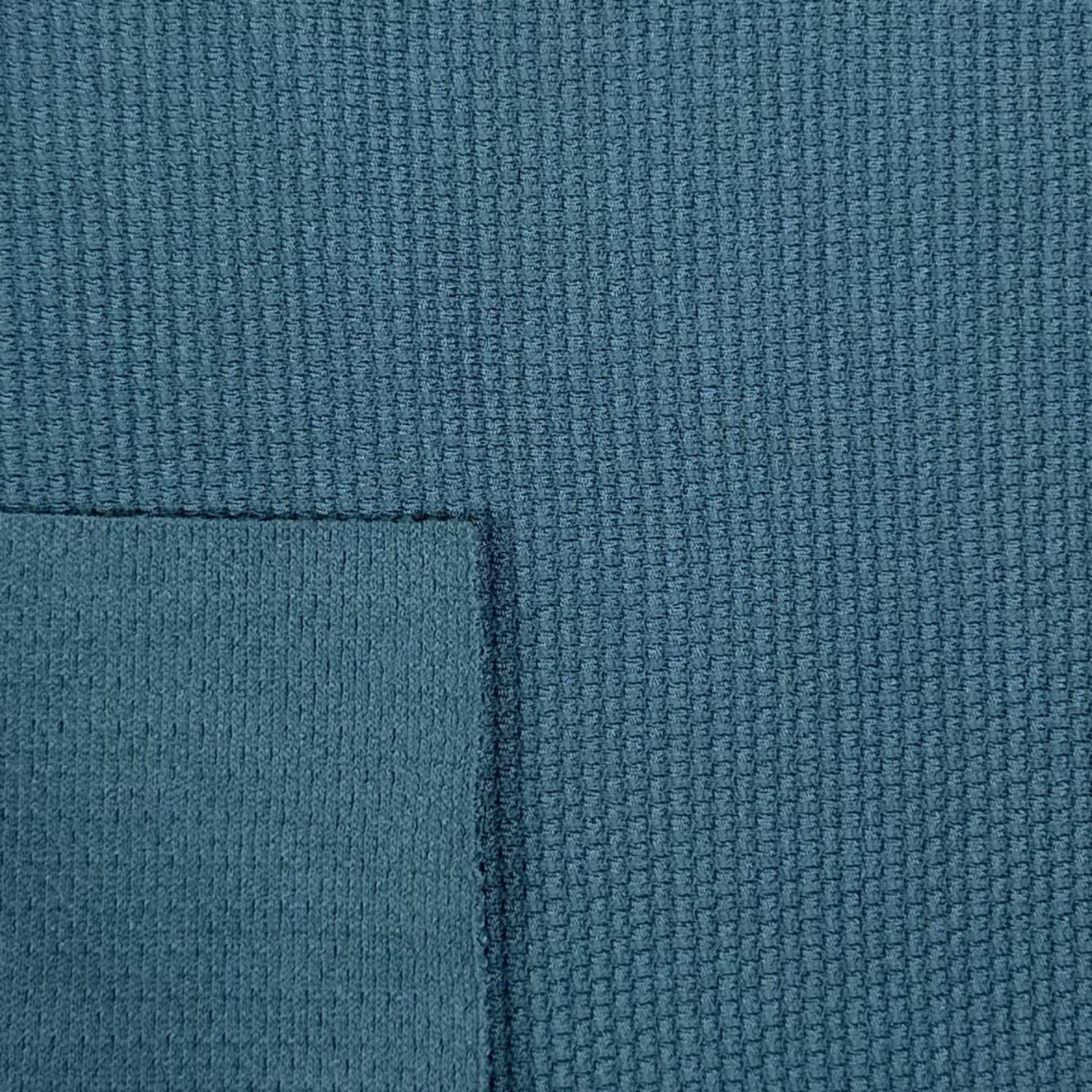 Close-up of textured blue fabric with a slight pattern