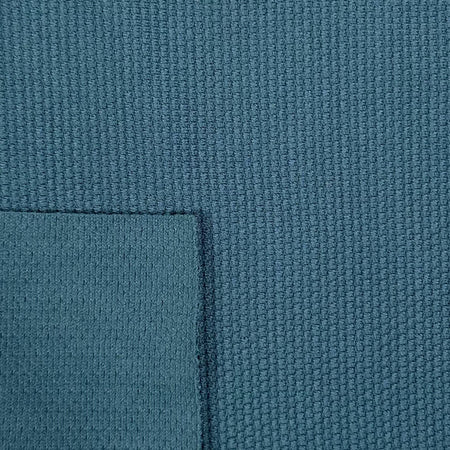 Close-up of textured blue fabric with a slight pattern
