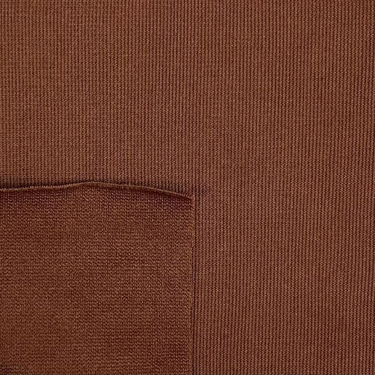Close-up of brown fabric with a pocket