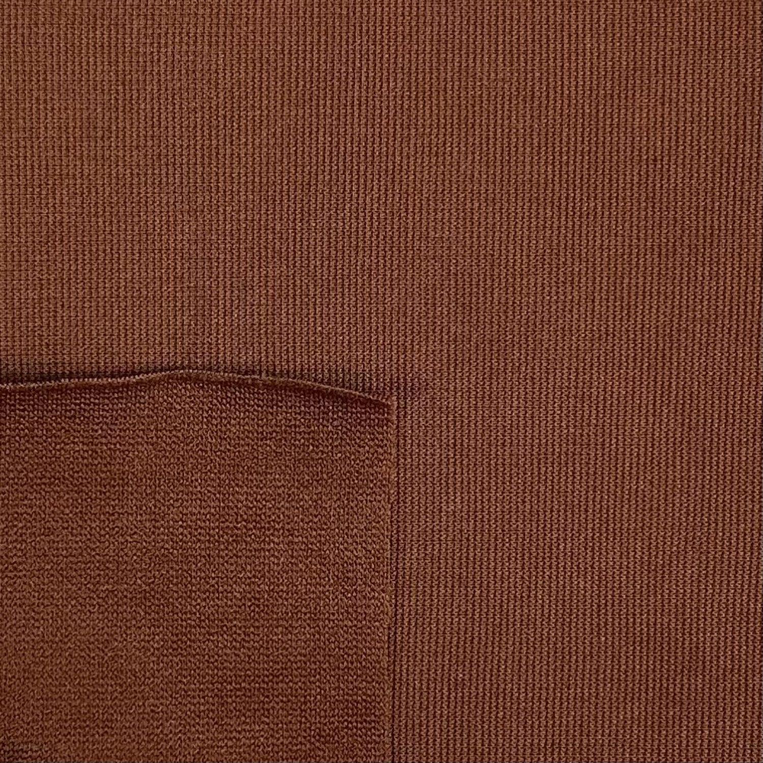 Close-up of brown fabric with a pocket