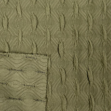 Close-up of textured green fabric with a patterned edge.