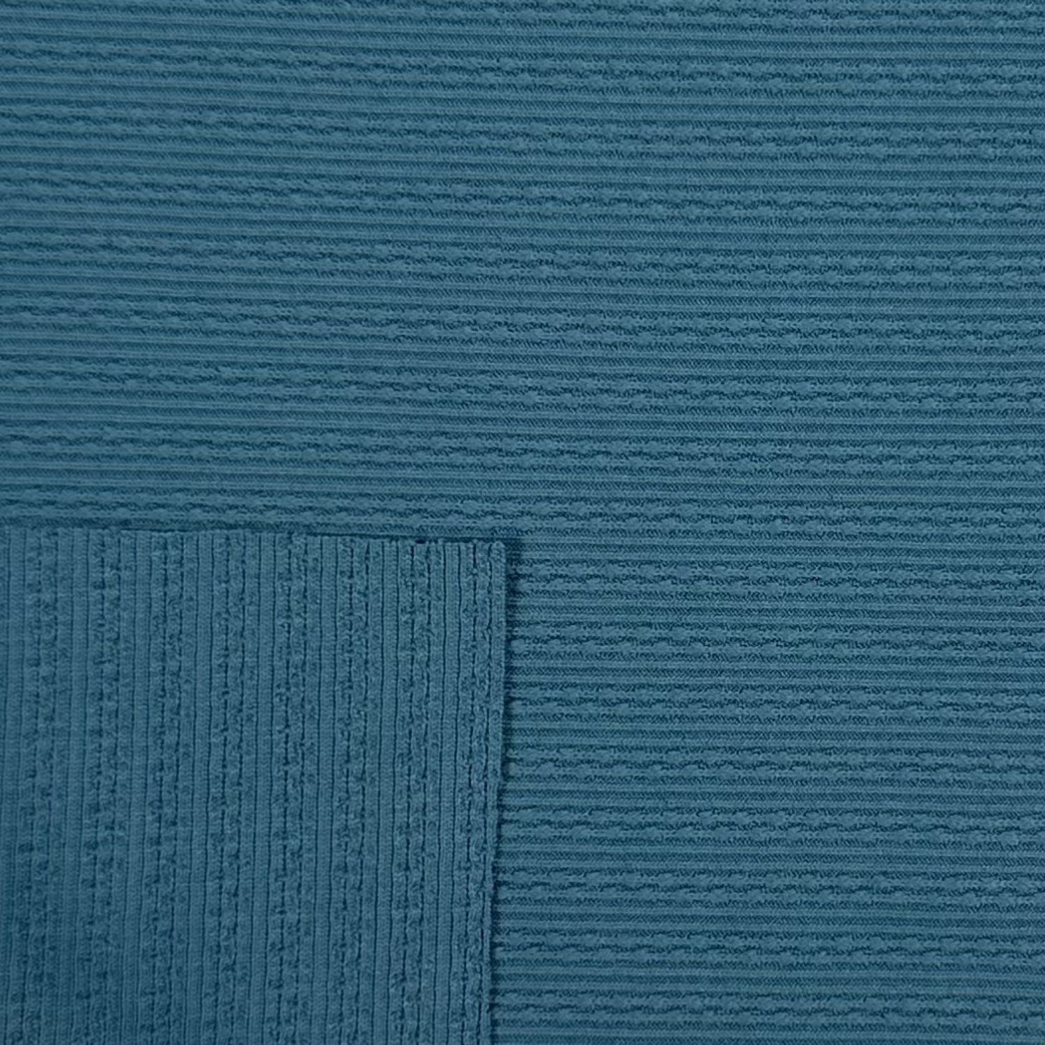 Close-up of textured blue fabric with a subtle pattern