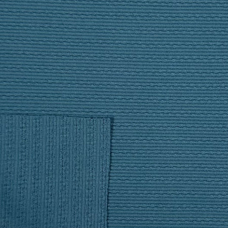Close-up of textured blue fabric with a subtle pattern