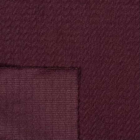 Close-up of maroon fabric with a subtle pattern