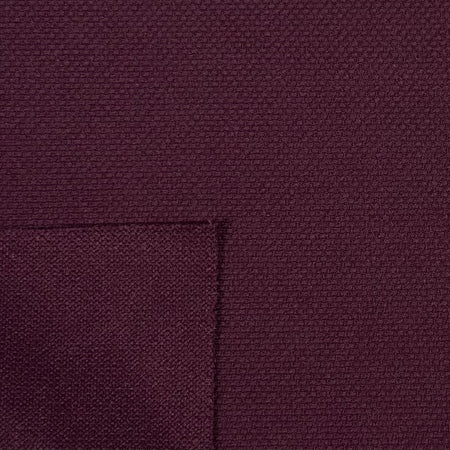 Close-up of a textured purple fabric with a pocket detail