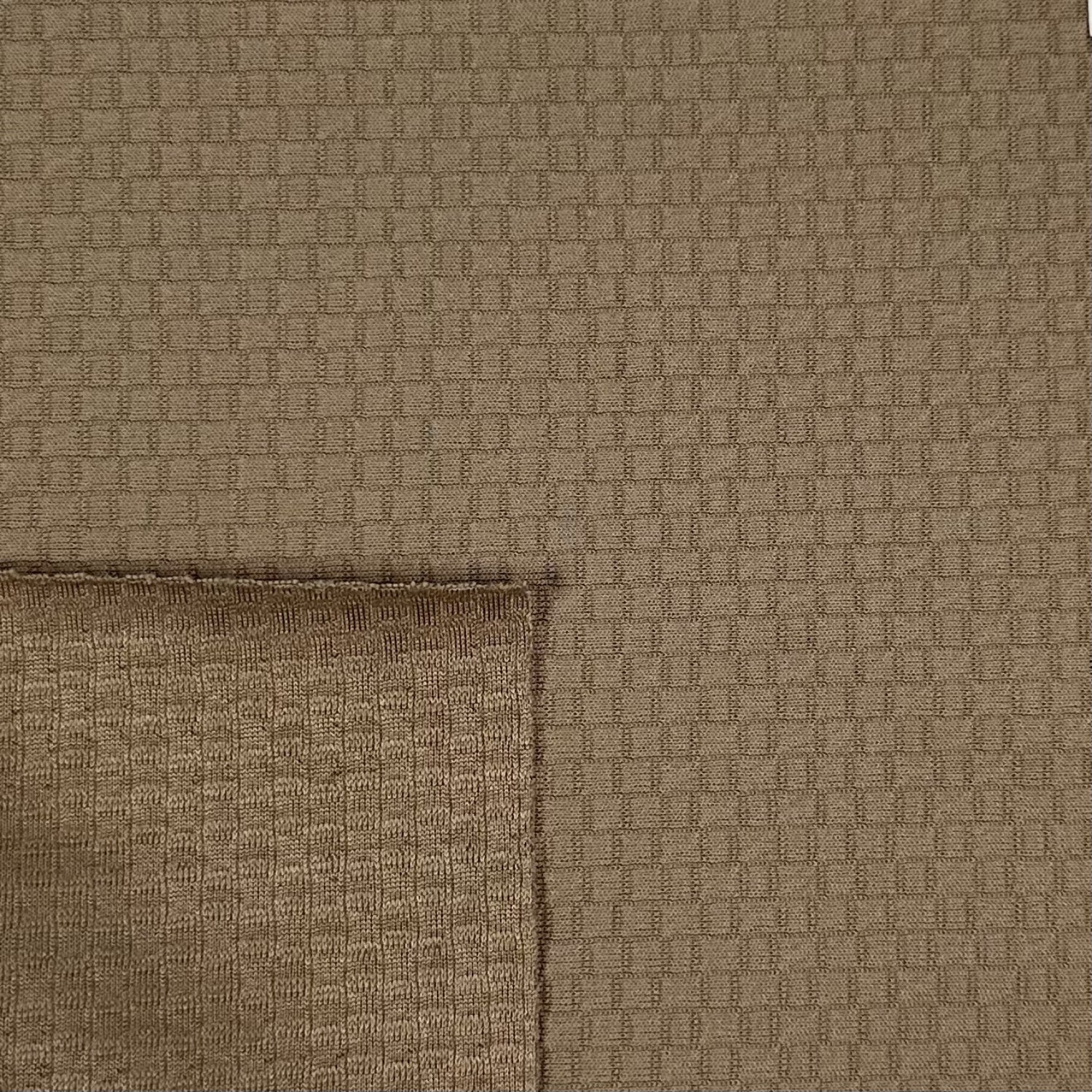 Close-up of brown textured fabric with a geometric pattern