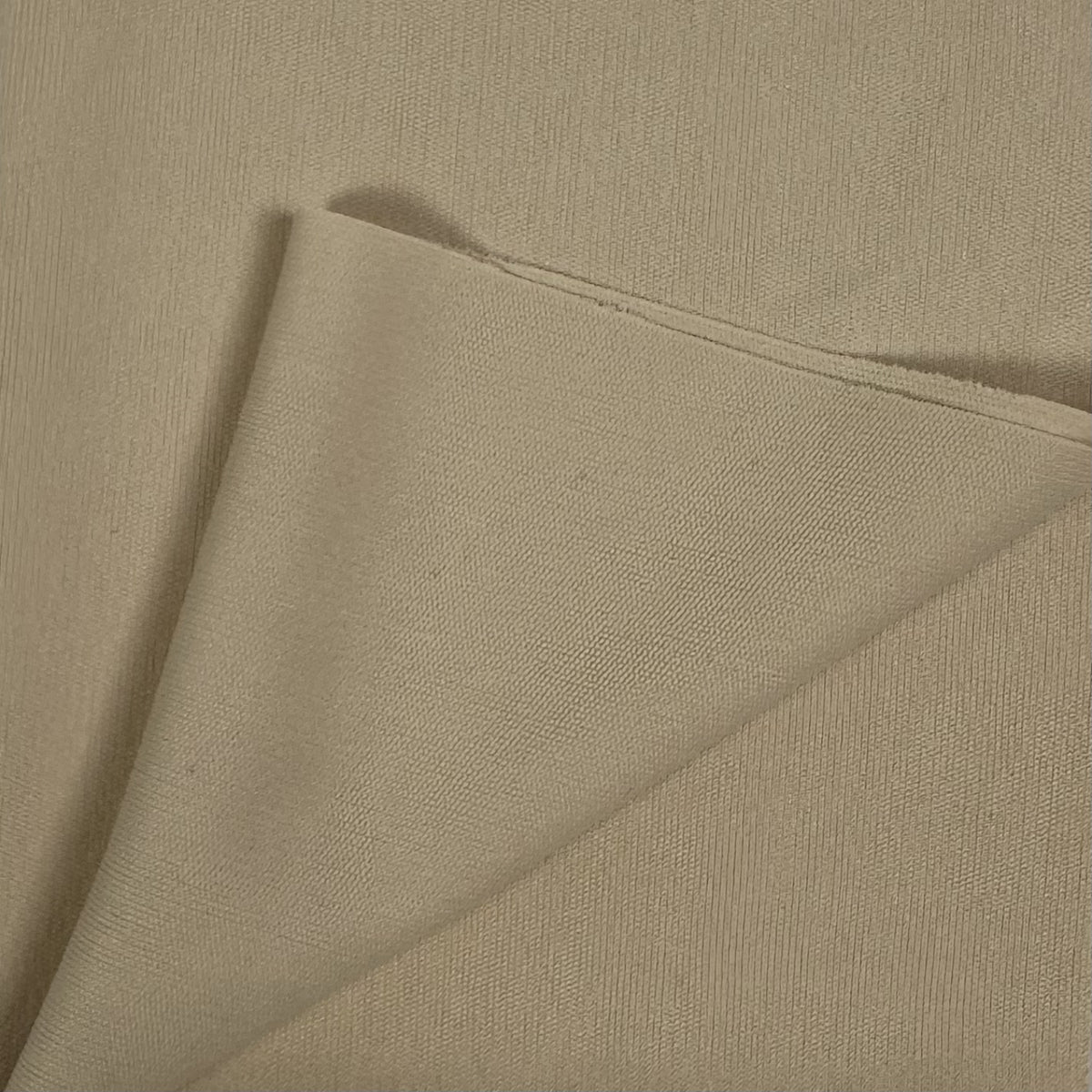 Close-up of beige fabric with a diagonal fold