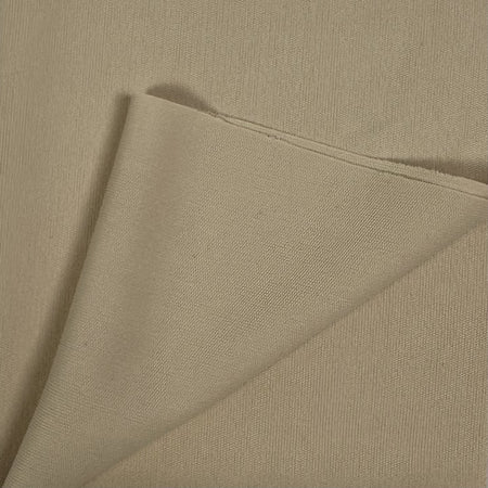 Close-up of beige fabric with a diagonal fold