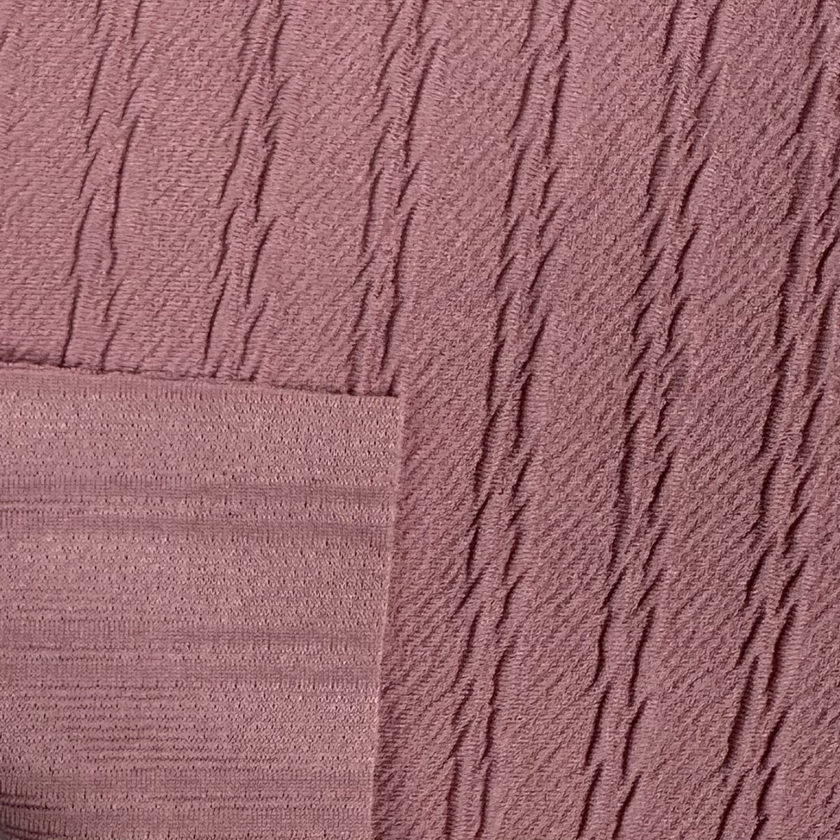 Close-up of textured pink fabric with diagonal lines