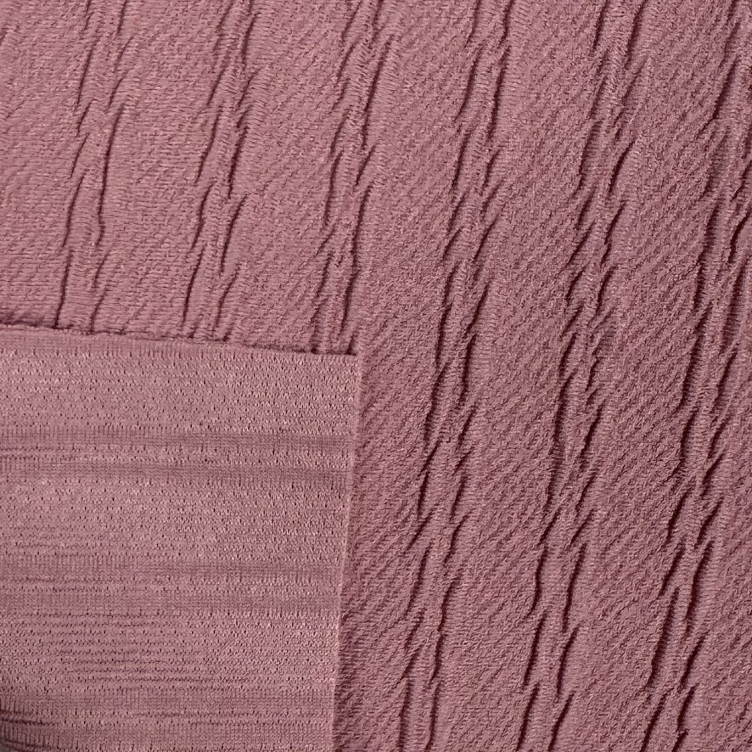 Close-up of textured pink fabric with diagonal lines