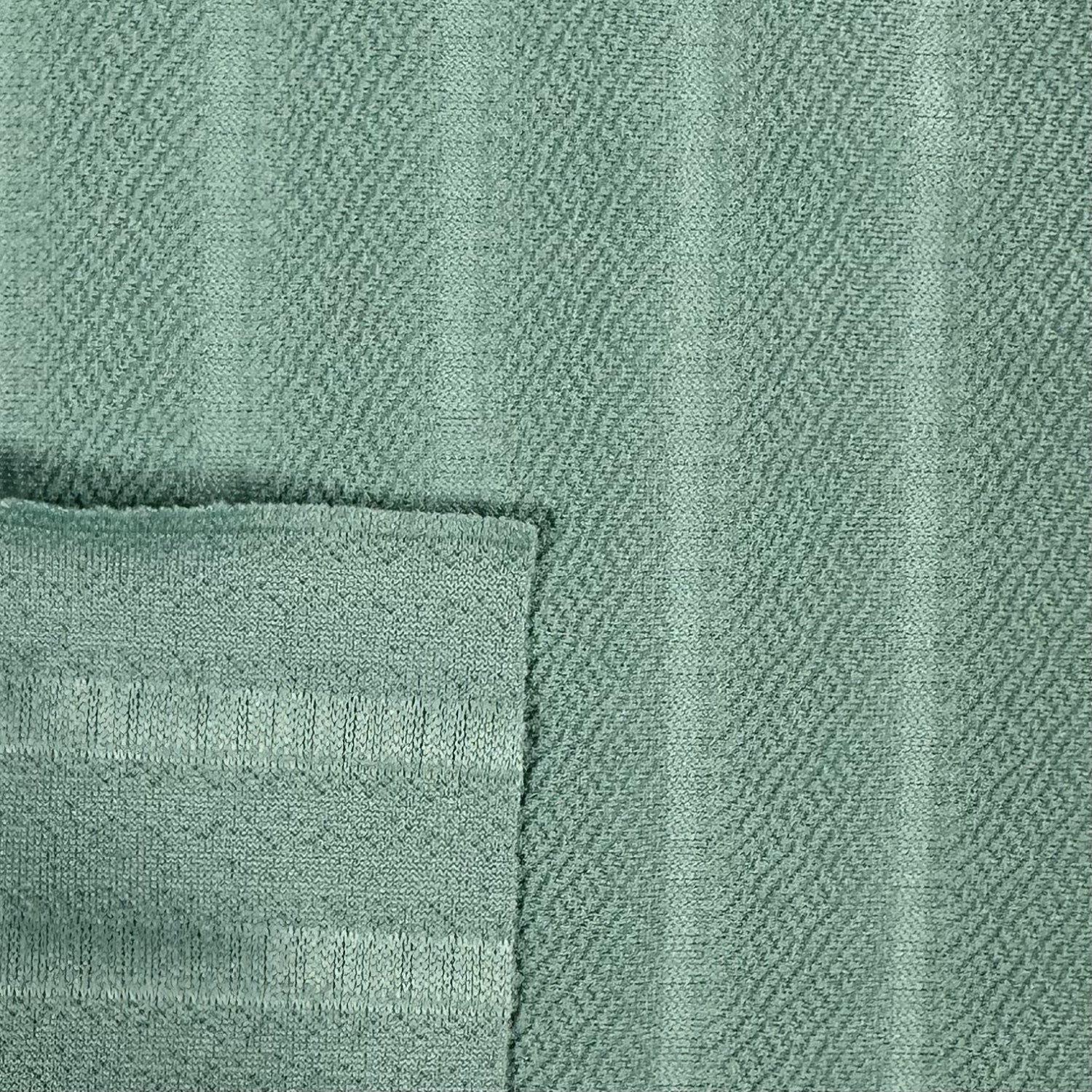 Close-up of a textured green fabric with a subtle pattern